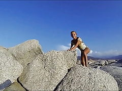 Climbing a Rock in a short Dress