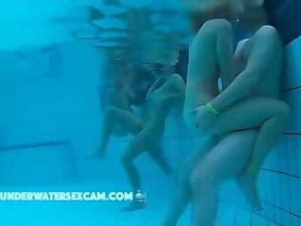 Witness these crazy nubile honeys enjoyment each other in a public pool, no shame!